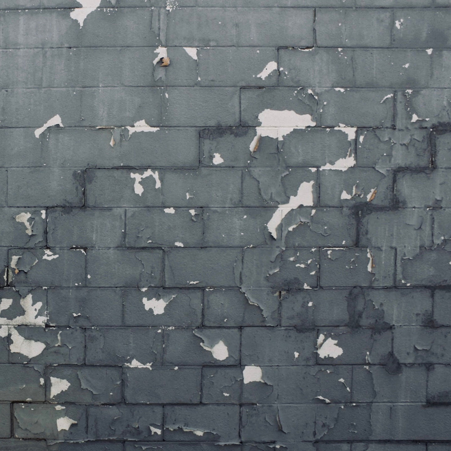 Photo of an old, grey brick wall