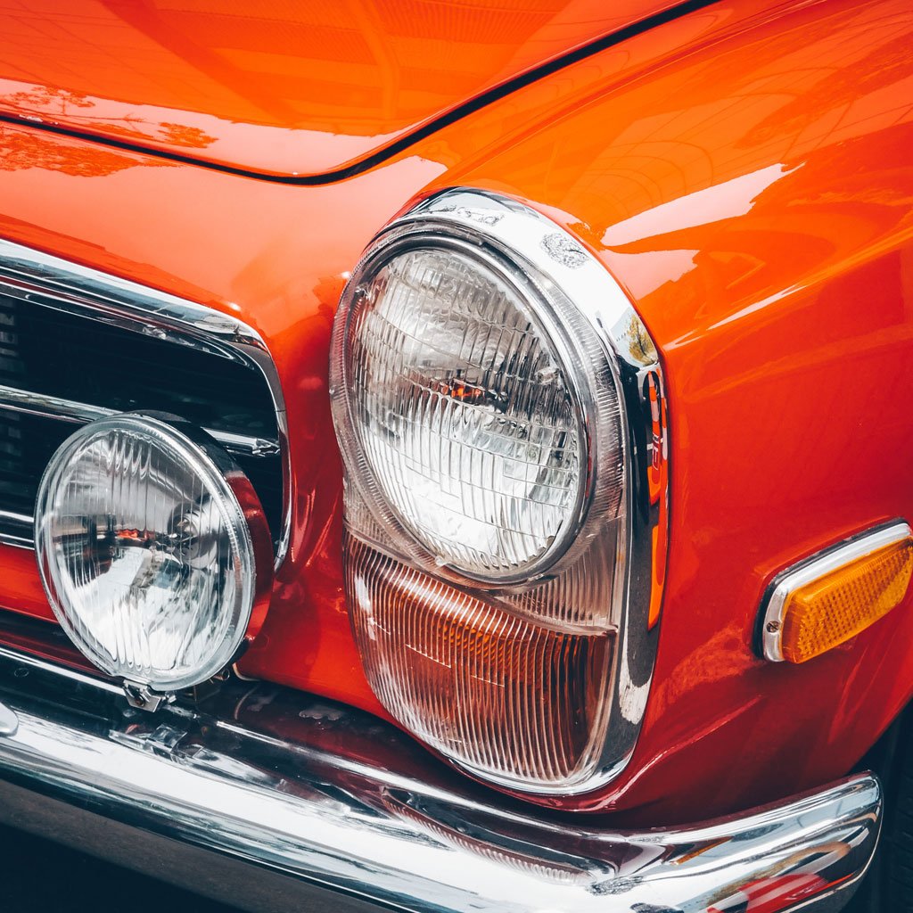 Macro photo of an orange automobile chasis.