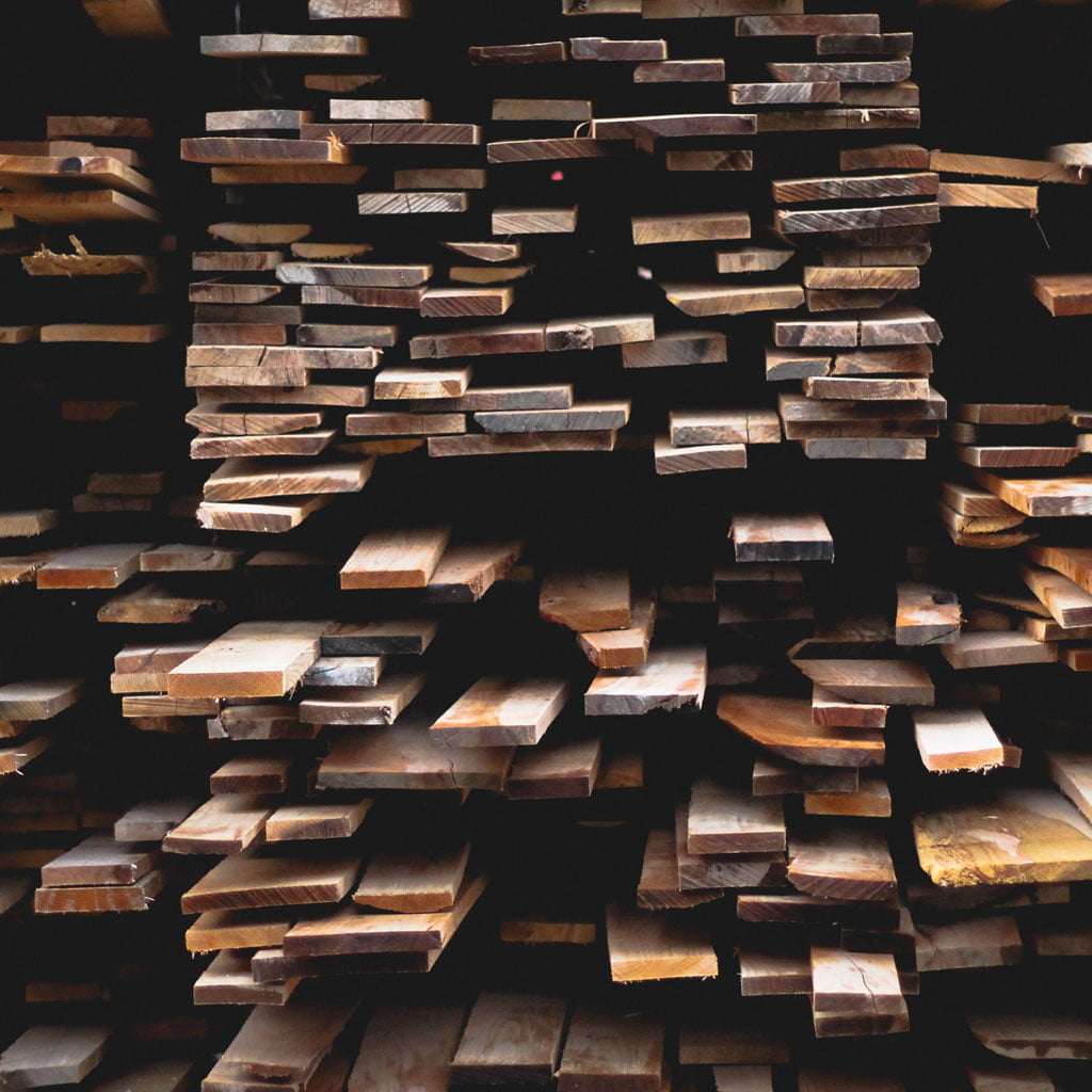 Photo of a large pile of wood planks