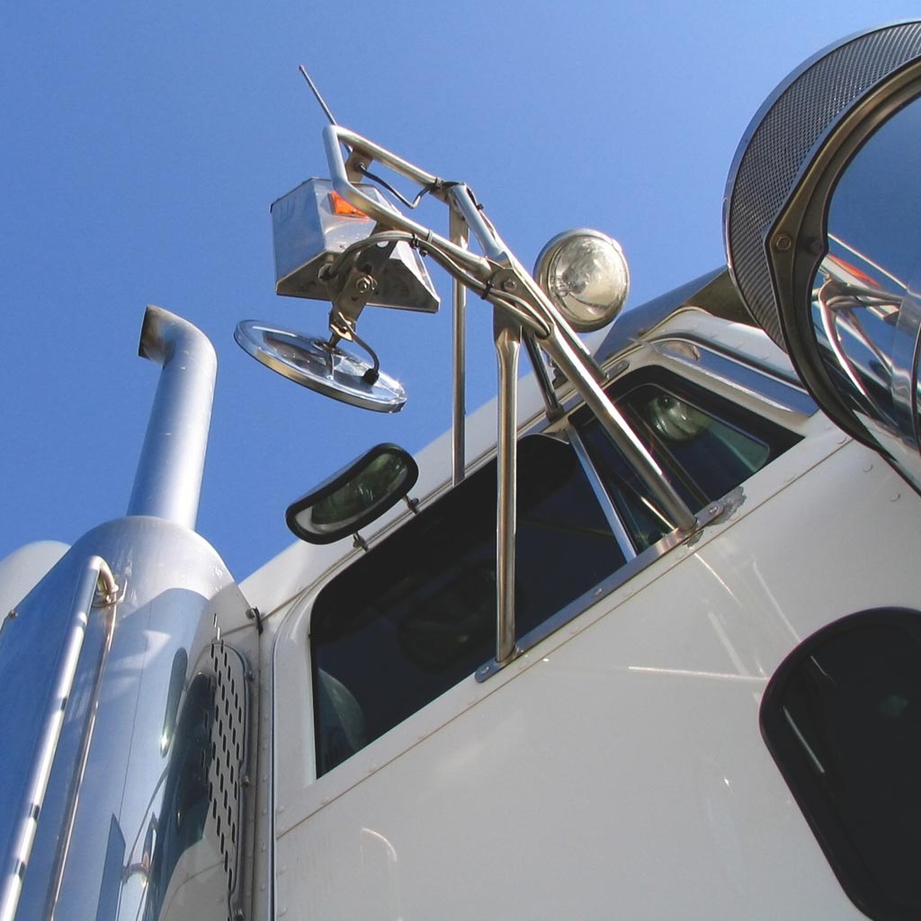 Photo of a high-cab semi truck from the ground indicating a fall and injury has occurred