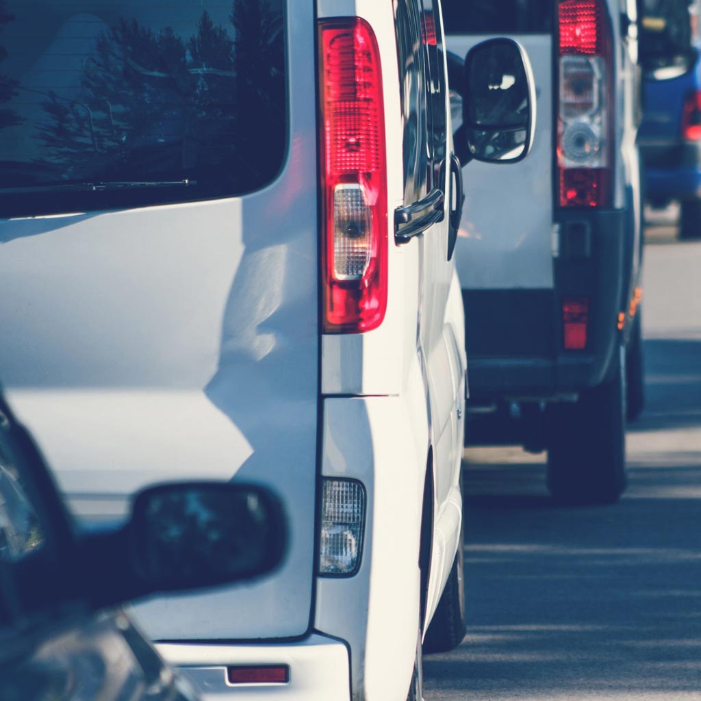 A row of commercial vans lined-up in traffic